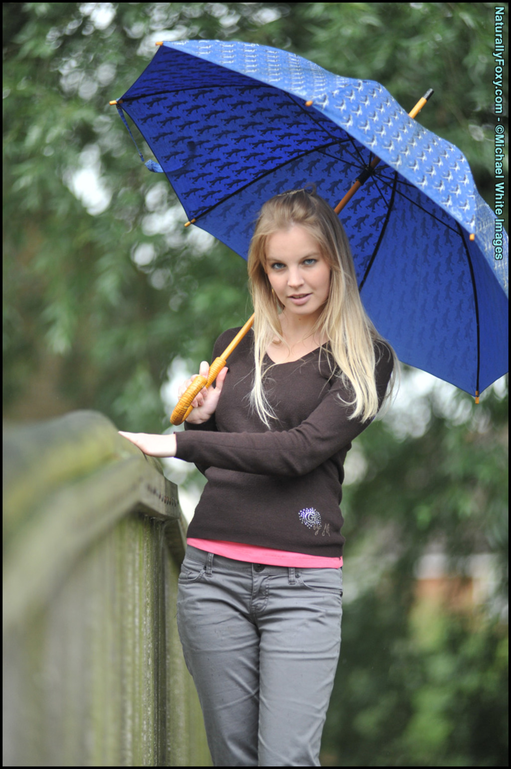 Blonde Girl Next-door Type Holds An Umbrella