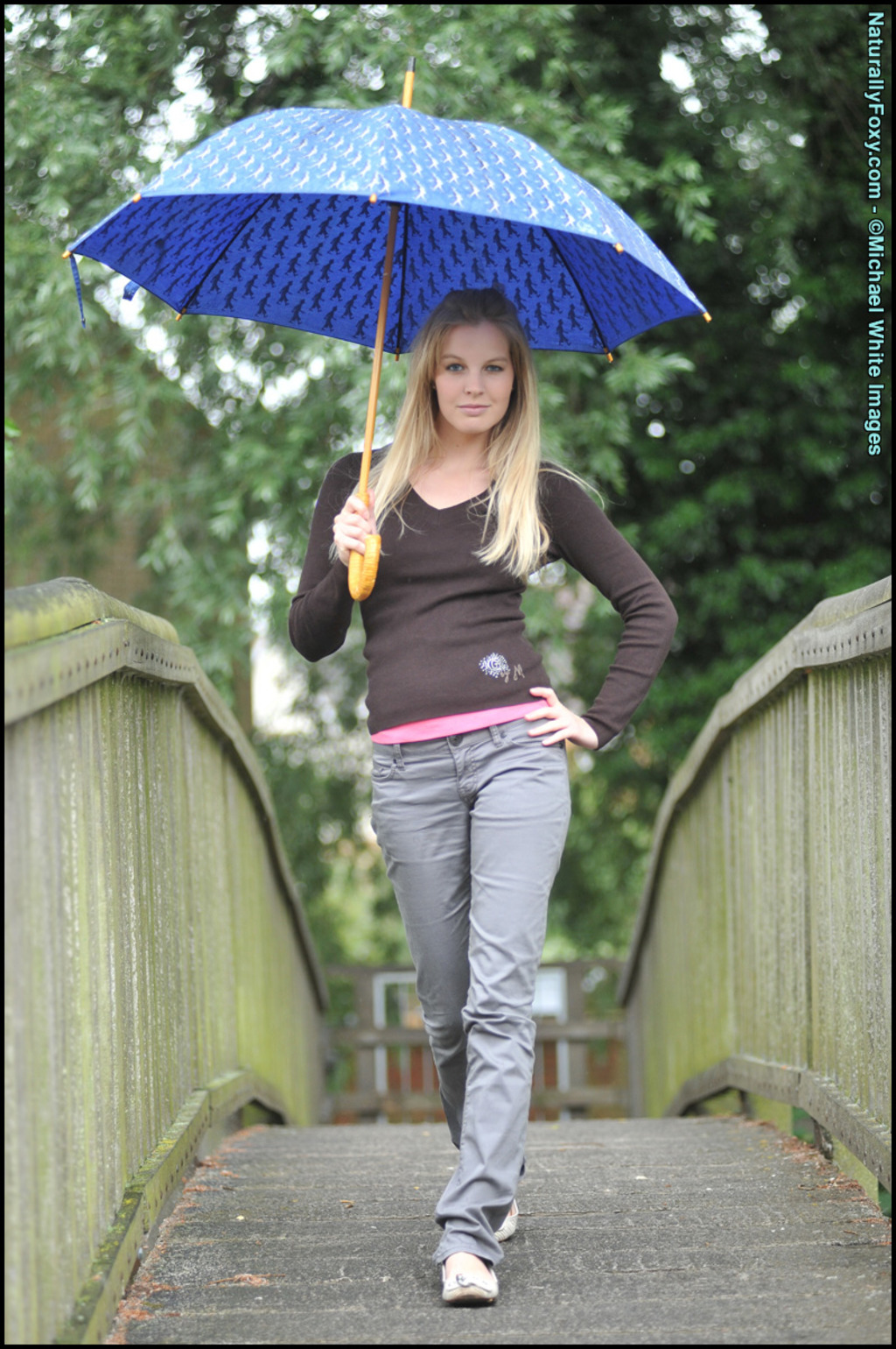 Blonde Girl Next-door Type Holds An Umbrella